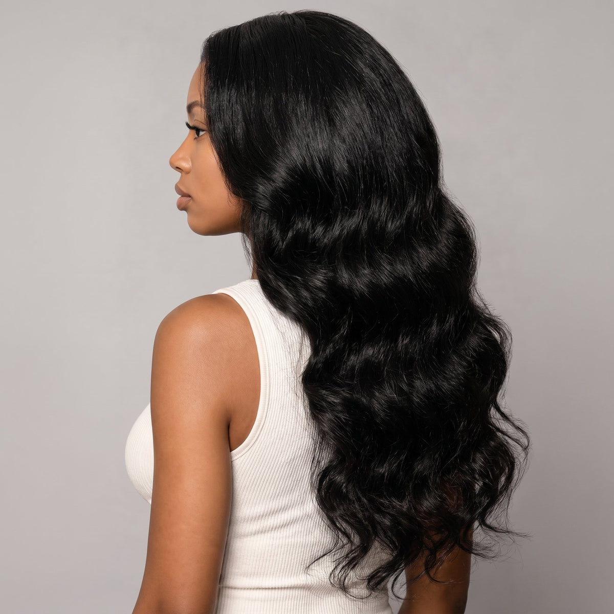 Body Wave bulk hair tied at the top on a white background.