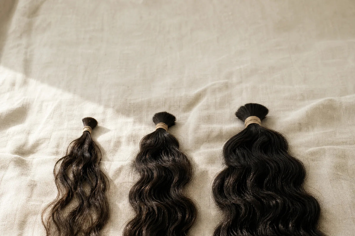 AI-generated illustration of three bundles of hair of different thickness.